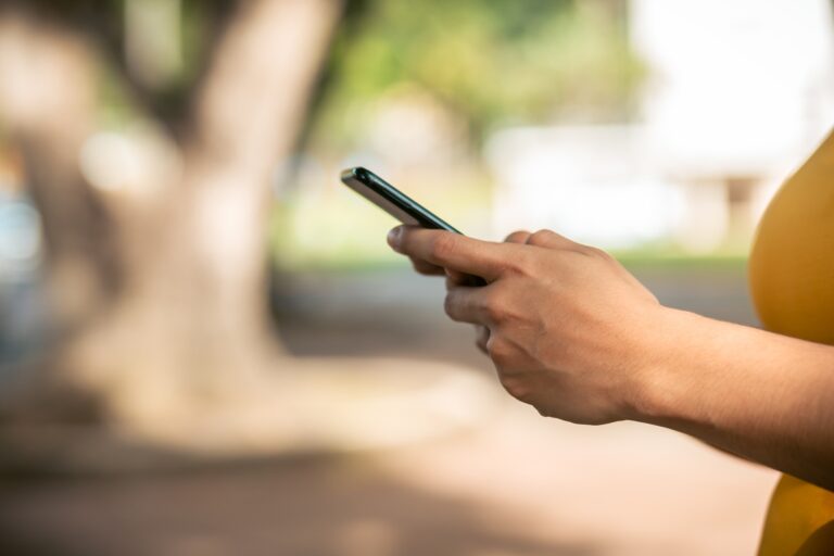 hands typing text message on the phone
